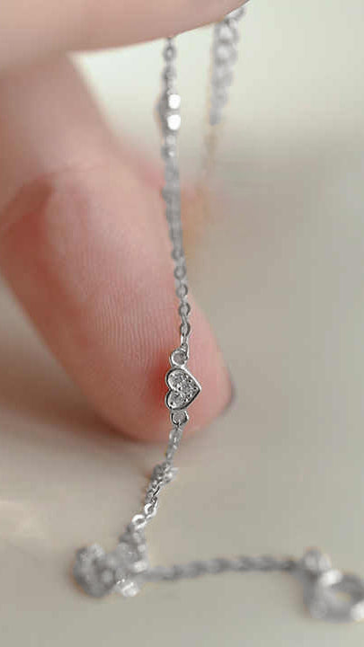 Silver Bracelet with Heart-Shaped Stations and Cubic Zirconia Accents