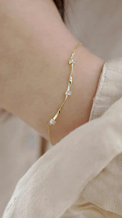 Gold Bracelet with Twist Bar Design and Three Cubic Zirconia Accents