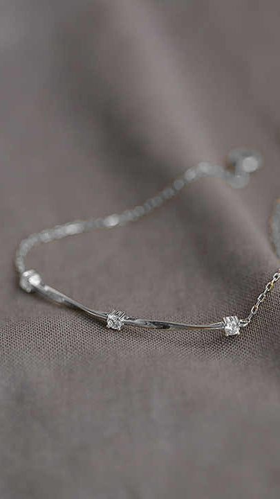 Silver Bracelet with Twist Bar Design and Three Cubic Zirconia Accents